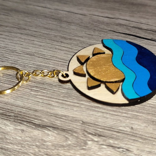 Handmade wooden summer keychain with laser cut sun and waves design
