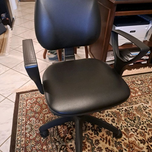 Office chair used with black leatherette upholstery