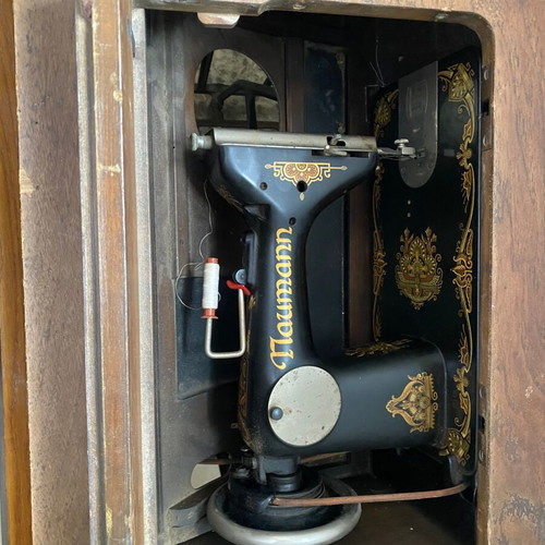 Naumann sewing machine used with cabinet and wheel