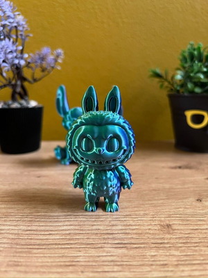 Labubu limited collectible figure with metallic green blue finish and cute aesthetic