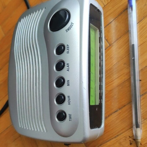 Digital alarm clock used with radio and minor display lines