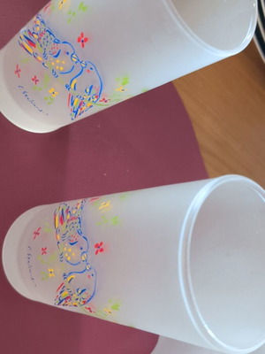 Glass pitcher and two glasses with Stathopoulos designs, like new