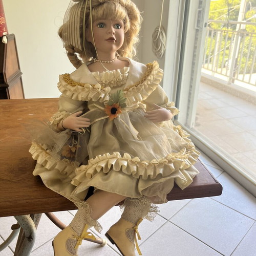 Porcelain doll sitting with curls, vintage