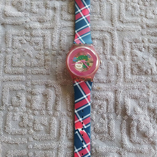 Swatch unicex watch used with transparent case and pink plastic strap