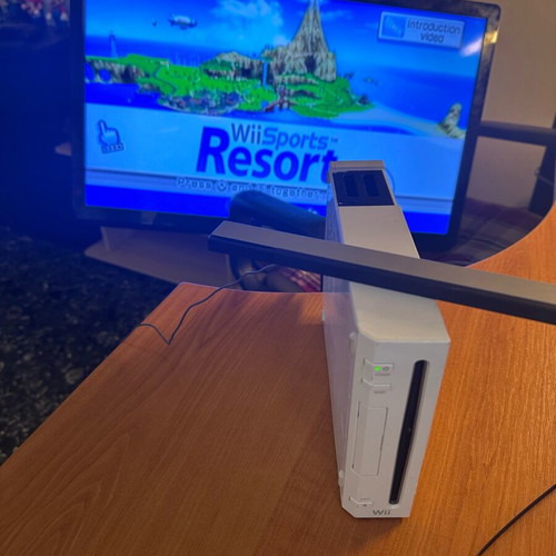 Nintendo Wii used with Wii Sports Resort game and accessories in moderate condition