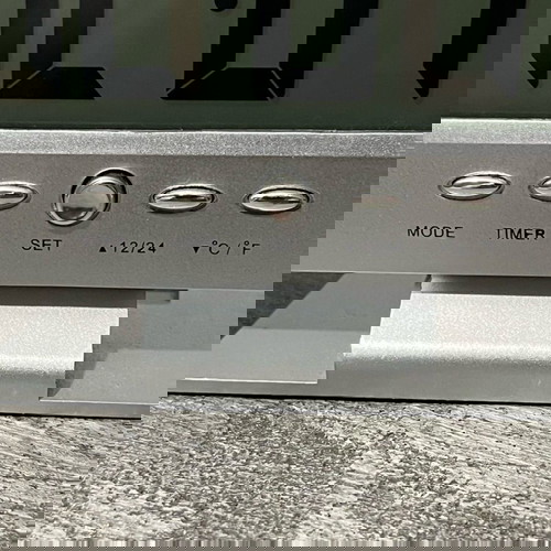 Digital table clock used with alarm and thermometer