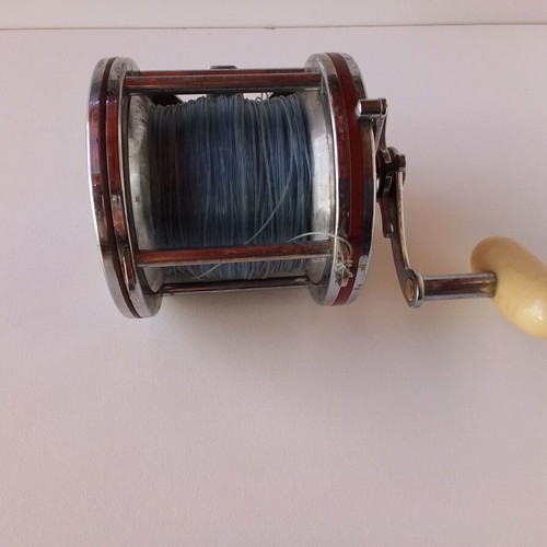 Penn Senator 114H fishing reel with large set of unused artificial lures and soft baits