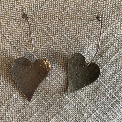 Silver earrings used in heart shape