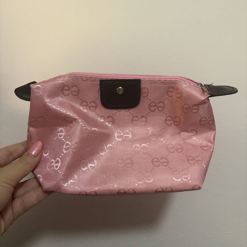 Pink toiletry bag like new with all-over logo pattern