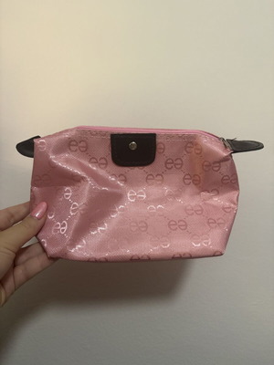 Pink toiletry bag like new with all-over logo pattern