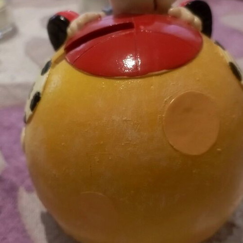Ceramic piggy bank used with bottom opening
