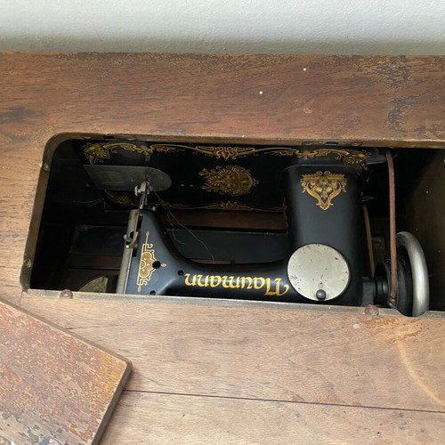 Naumann sewing machine used with cabinet and wheel