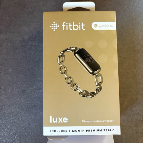Fitbit Luxe smartwatch used with charger and case