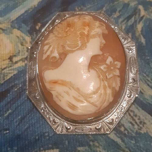 Vintage brooch like new with silver frame and carved bone relief