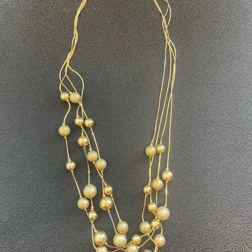 Statement necklace used with shiny and matte gold beads