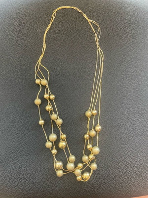 Statement necklace used with shiny and matte gold beads