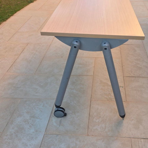 Dromeas desk with wheels used, light wood surface and metal frame
