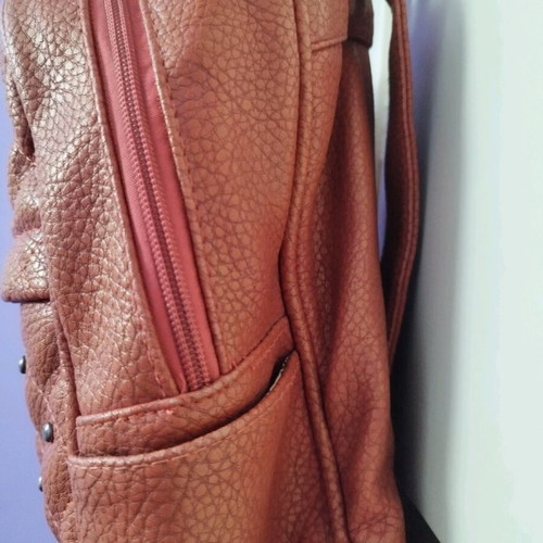 Backpack used red bag with quilted front zipper