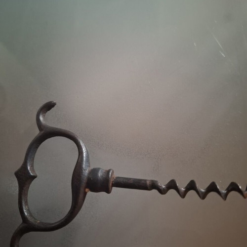 Old metal corkscrew bottle opener with handmade ring handle