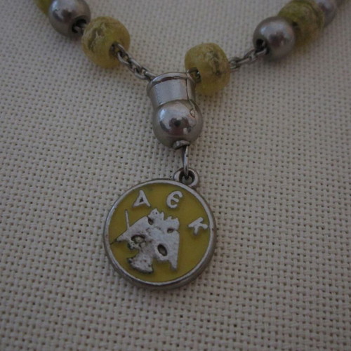 Vintage knotted AEK komboloi used with metal emblem