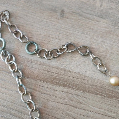 Long necklace chain with decorative elements like new, gold-colored