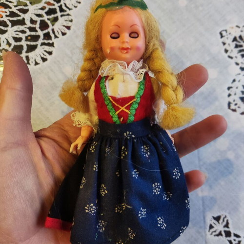 Retro doll used with traditional costume and broken leg