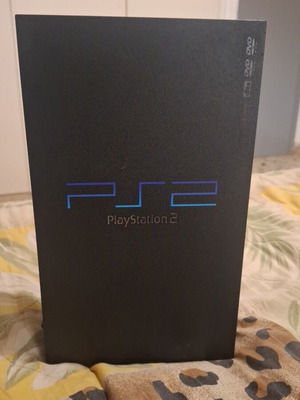 Sony PlayStation 2 console with 2 controllers, memory card and 5 games
