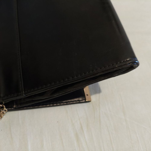 Black clutch bag with gold chain used, synthetic leather
