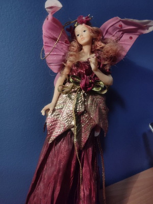 Decorative fairy angel figurine with wings in burgundy, pink and gold shades