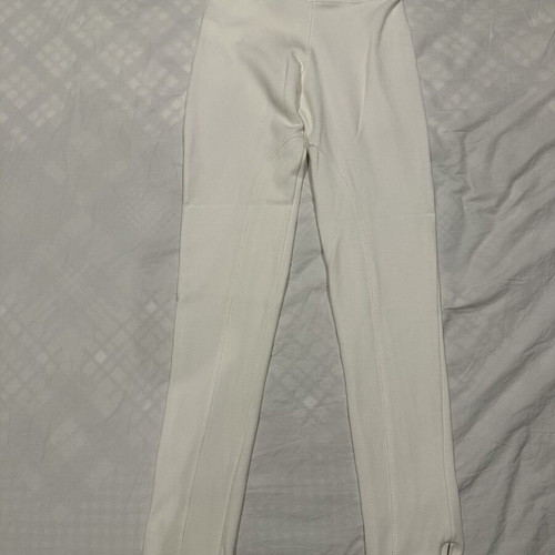 White elastic slim fit pants with ankle zippers