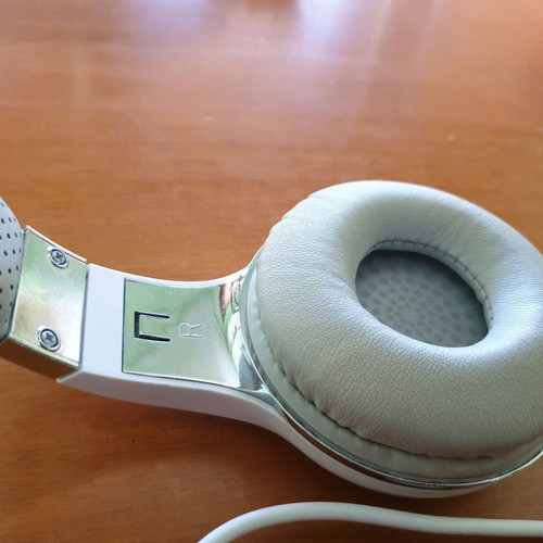Bluetooth headphones used, white with MP3 and memory card options
