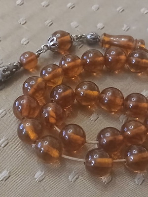 Komboloi pressed amber worry beads used with silver elements and tassel