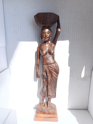 Rosewood figure of woman with basket from Bali, like new