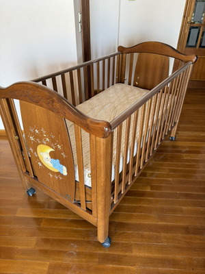 Children's crib used with storage space and adjustable railing