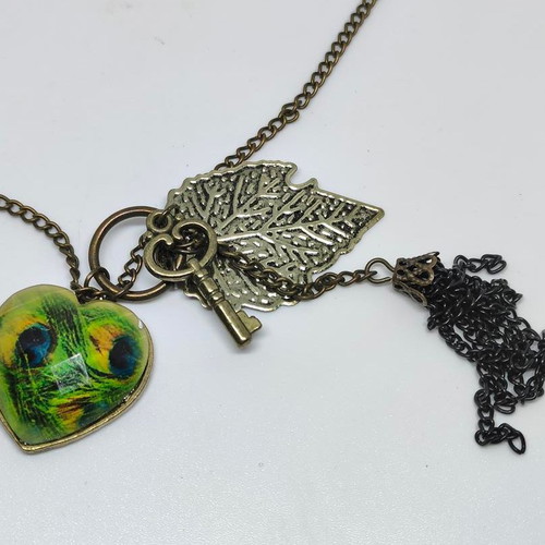 Vintage necklace with antique bronze elements and peacock feather heart pendant like new