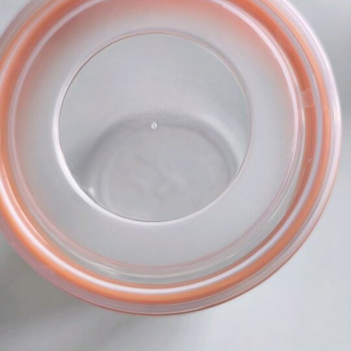 Storage container round like new, transparent with orange lid