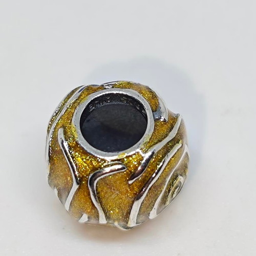 Silver charm bead with gold glitter enamel spiral design like new
