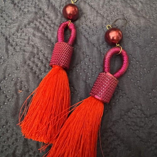 Red earrings with intricate binding and tassel like new