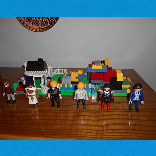 Building toy with Lego bricks and 6 Play Mobil figures used