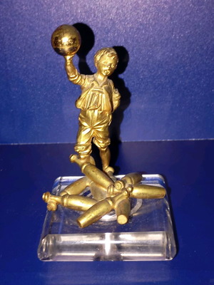 Sculpture of child playing bowling used, bronze with glass base