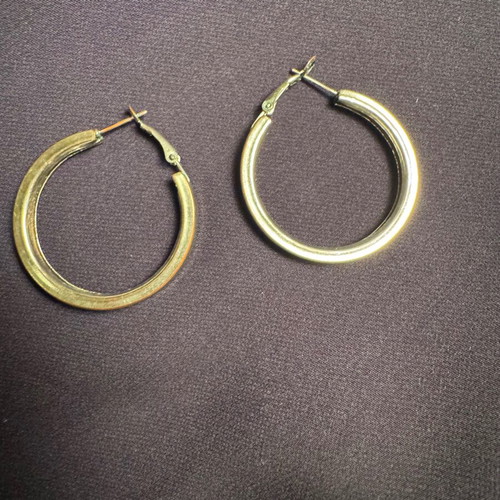 Thick silver hoop earrings used with some imperfections