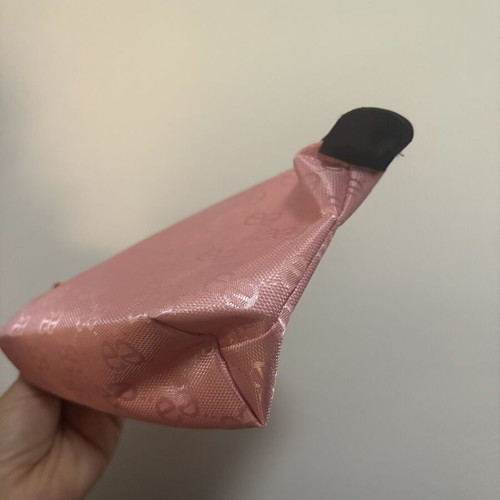Pink toiletry bag like new with all-over logo pattern