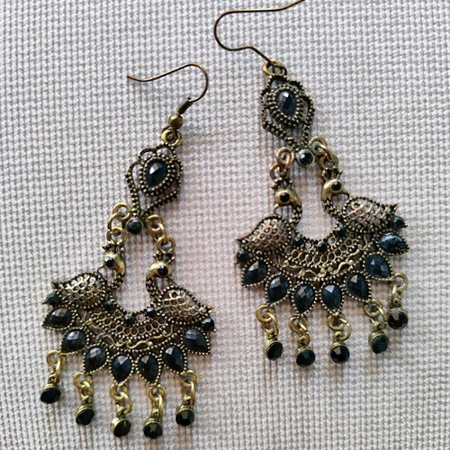 Long metal earrings used, black and gold