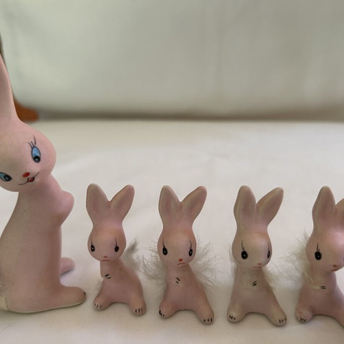 Vintage ceramic pink bunny family figurines with decorative Easter egg