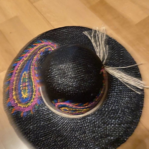 Painted hat on black background new for distinctive ladies