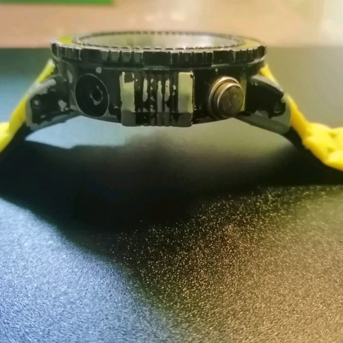 Watch with yellow strap missing one button, works