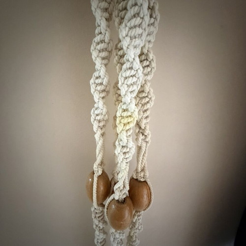 Macrame plant hanger used with wooden beads for pots