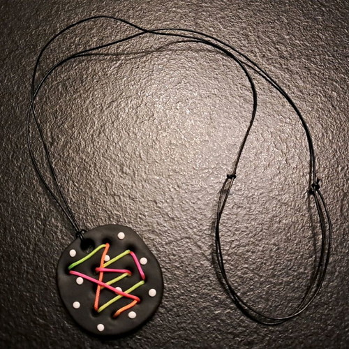 Handmade psychedelic fluo pendant with colorful cord on black base like new