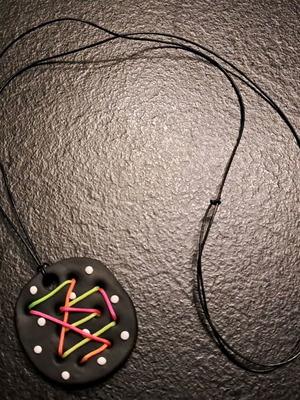 Handmade psychedelic fluo pendant with colorful cord on black base like new
