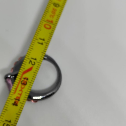 Ring with purple central crystal and pink details in black metal like new